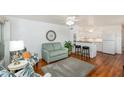Open-concept living area showcasing wood floors, modern furniture, and seamless flow to the kitchen at 4154 56Th N St # 720, Kenneth City, FL 33709