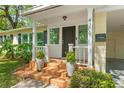 Inviting front porch with brick steps, white columns, and manicured landscaping at 4309 W Empedrado St, Tampa, FL 33629