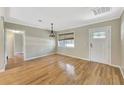 Bright entryway boasting hardwood floors, and a decorative glass front door, and fresh neutral paint at 4619 W Bay Villa Ave, Tampa, FL 33611