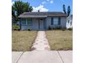 Inviting single-story home with a patterned walkway leading to the front door, and tidy lawn at 5048 5Th S Ave, St Petersburg, FL 33707