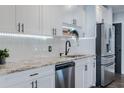 Stylish kitchen featuring granite counters, stainless appliances and modern lighting at 5509 Bluejay Ln, Tampa, FL 33625