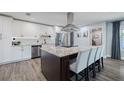 Modern kitchen featuring white cabinetry, stainless appliances and a large center island at 5509 Bluejay Ln, Tampa, FL 33625