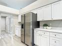 Bright eat-in kitchen boasts stainless steel refrigerator and expansive countertops, perfect for entertaining at 5809 Silas Creek Ln, Wesley Chapel, FL 33545