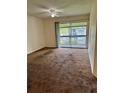 Bedroom with a ceiling fan, carpet, and sliding doors to the outdoor screened in patio at 6324 Newtown Cir # 24B2, Tampa, FL 33615