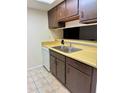 Kitchen with stainless steel sink, tile floor and white dishwasher at 6324 Newtown Cir # 24B2, Tampa, FL 33615
