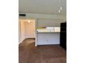 Spacious living room with carpet, and open view into the kitchen area at 6324 Newtown Cir # 24B2, Tampa, FL 33615