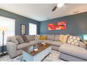 Spacious living room featuring a large sectional sofa, stylish decor, and ample natural light at 6412 S Richard Ave, Tampa, FL 33616
