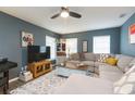 Comfortable living room with a sectional sofa, ceiling fan, and an area rug at 6412 S Richard Ave, Tampa, FL 33616