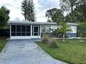 Cozy single-story home with a well-kept lawn and blue driveway at 6901 10Th N St, St Petersburg, FL 33702
