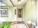 Cozy front porch with decorative touches, creating a welcoming entrance to the home at 6901 Arbor Oaks Ct, Bradenton, FL 34209