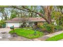 Lovely home featuring a well-kept lawn and colorful landscaping, adding to its curb appeal at 6901 Arbor Oaks Ct, Bradenton, FL 34209