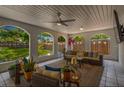 Cozy covered patio with comfortable seating, string lights, and view of the backyard at 7210 S Sparkman St, Tampa, FL 33616