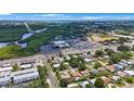 Scenic aerial view showcasing the neighborhood, nearby shops, restaurants and natural green space at 8339 75Th Ave, Seminole, FL 33777