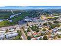 Scenic aerial view showcasing the neighborhood, nearby shops, restaurants and natural green space at 8339 75Th Ave, Seminole, FL 33777