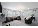 Cozy living room featuring a large leather sofa, accent chair, and a view of the front entrance at 8339 75Th Ave, Seminole, FL 33777