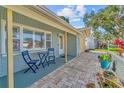 Inviting front porch with seating and a neatly paved walkway to the entrance at 10339 111Th St, Largo, FL 33778