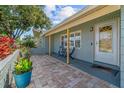 Welcoming front porch with a cozy seating area and decorative potted plants, offering curb appeal at 10339 111Th St, Largo, FL 33778