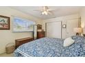 Cozy bedroom with blue floral bedding, dresser, and sliding closet doors with natural light at 11775 84Th Ave, Seminole, FL 33772