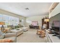 Bright living room featuring a comfortable sectional sofa, terrazzo floors, and ample natural light at 11775 84Th Ave, Seminole, FL 33772
