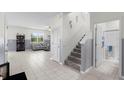 Inviting hallway with tile flooring, staircase, and a view into the spacious living area, creating a seamless transition at 12481 Aston Dr, Hudson, FL 34669