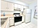 Cozy kitchen with essential appliances, ample cabinet space, and a bright, clean atmosphere at 13926 Mission Oaks Blvd, Seminole, FL 33776
