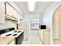 Bright kitchen with a window, classic appliances and tile flooring offers a clean, simple design at 13926 Mission Oaks Blvd, Seminole, FL 33776