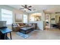 Inviting living room with tile flooring, neutral paint, and ample natural light at 14320 Tree Swallow Way, Lakewood Ranch, FL 34202