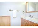 Functional bathroom featuring a wooden vanity, towel rack, and neutral color palette at 1799 N Highland Ave # 185, Clearwater, FL 33755