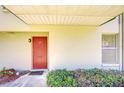 Close up on the entrance with its red door and green bushes at 1799 N Highland Ave # 185, Clearwater, FL 33755