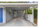 Covered carport area with a blue door and access to the main house at 2204 E Idlewild Ave, Tampa, FL 33610