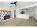 Open-concept living room with a decorative fireplace and stylish flooring at 2204 E Idlewild Ave, Tampa, FL 33610