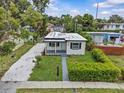 An aerial view of a charming single-story home with a gravel driveway and a manicured lawn at 2465 16Th S Ave, St Petersburg, FL 33712
