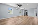 Spacious living room with modern light fixtures, neutral walls, and sleek hardwood floors at 2465 16Th S Ave, St Petersburg, FL 33712