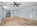 Open-concept living room featuring a ceiling fan, hardwood flooring and views of adjacent rooms at 2465 16Th S Ave, St Petersburg, FL 33712