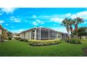 Screened lanai with nicely manicured landscaping in backyard at 2527 Terracina Dr, Venice, FL 34292