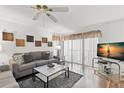 Inviting living room with plush grey sofa, bright lighting, and modern décor at 2699 Pine Ridge E Way # H2, Palm Harbor, FL 34684