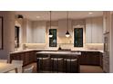 Modern kitchen featuring an island with seating, stylish pendant lighting, and marble countertops at 2719 13Th N St, St Petersburg, FL 33704