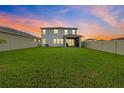 Spacious backyard featuring a large grassy area and a screened in porch at 32136 Conchshell Sail St, Wesley Chapel, FL 33545