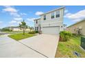 Attractive two-story home with a long driveway, two-car garage and manicured lawn at 32136 Conchshell Sail St, Wesley Chapel, FL 33545