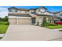 Charming two-story home features a two-car garage and a beautifully landscaped front yard at 3559 Maple Bay Ln, Land O Lakes, FL 34638