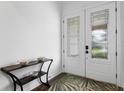 Light and bright entryway with decorative front door and modern console table at 3559 Maple Bay Ln, Land O Lakes, FL 34638
