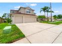 Attractive residence featuring a wide driveway, lush lawn, and a convenient three-car garage at 3633 Morgans Bluff Ct, Land O Lakes, FL 34639