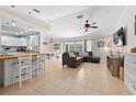 Bright and open living room with tile floors, sectional sofa, kitchen and dining area at 3905 31St W Ave, Bradenton, FL 34205
