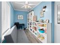 Inviting home office featuring a gray futon, white bookshelves, and nautical decor at 3905 31St W Ave, Bradenton, FL 34205