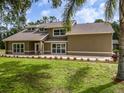 Charming home features large windows, manicured lawn, and fresh landscaping at 4044 Red Fox Ct, Wesley Chapel, FL 33543
