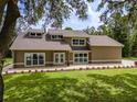Charming home features large windows, manicured lawn, and fresh landscaping at 4044 Red Fox Ct, Wesley Chapel, FL 33543