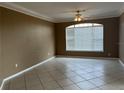 Bedroom featuring tile floors, neutral paint, and a large window at 4305 Bayside Village Dr # 301, Tampa, FL 33615