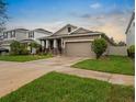 The home shows a well-maintained yard and driveway with a welcoming exterior at 5006 Jackel Chase Dr, Wimauma, FL 33598