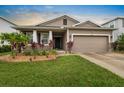 A beautiful single-Gathering home with a well-kept lawn and attached two-car garage at 5006 Jackel Chase Dr, Wimauma, FL 33598