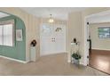 Spacious foyer featuring tile flooring, a decorative chandelier, and a view into the living area at 5078 Florentine Ct, Spring Hill, FL 34608